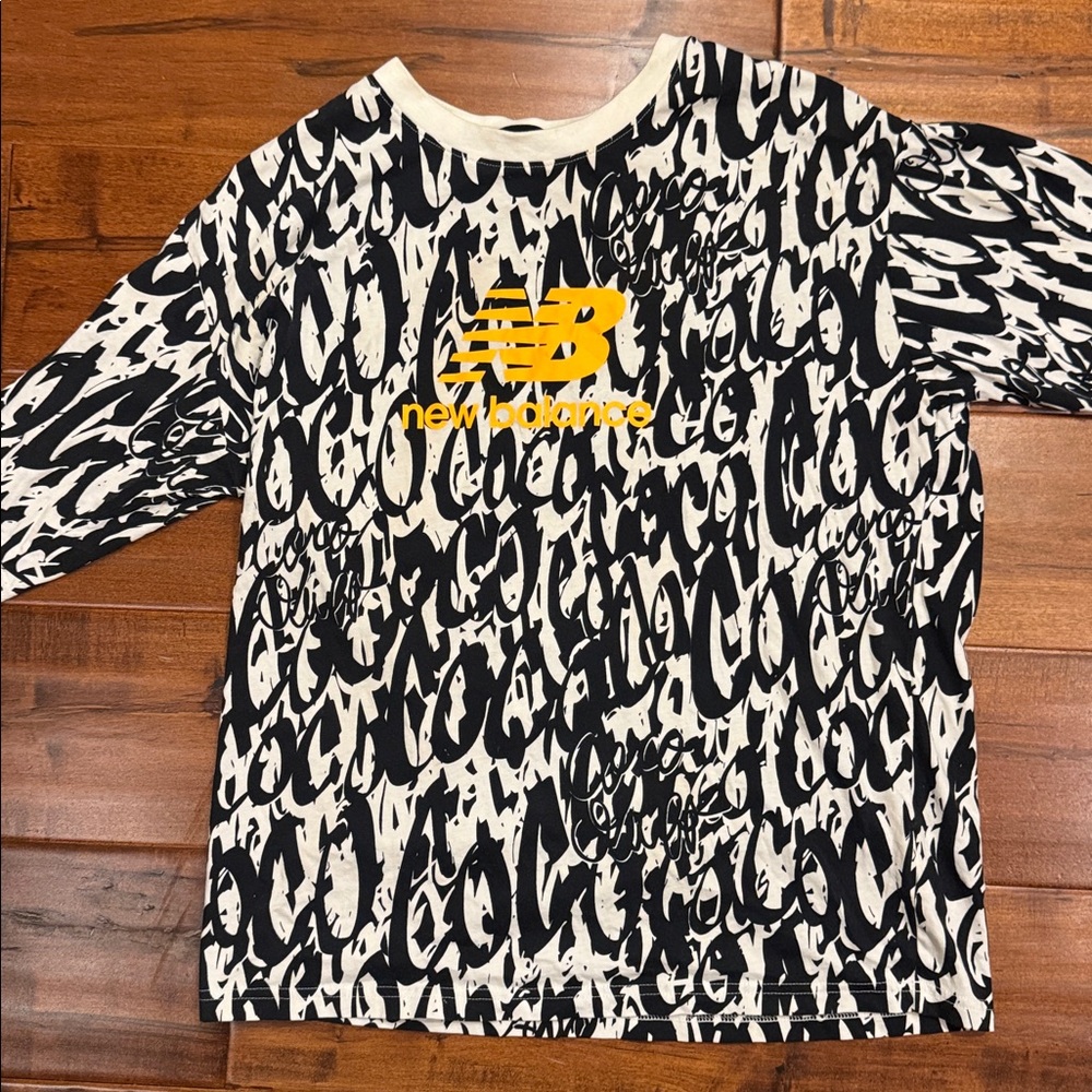 New Balance Black and White Tee with orange Logo